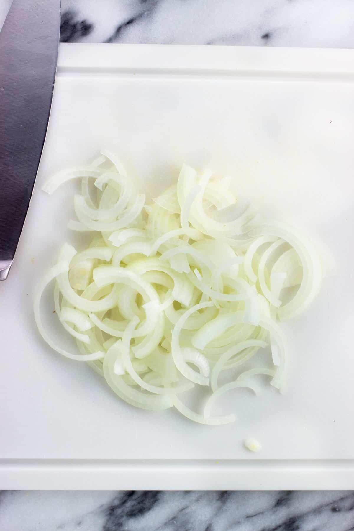 Sliced onion on a cutting board.