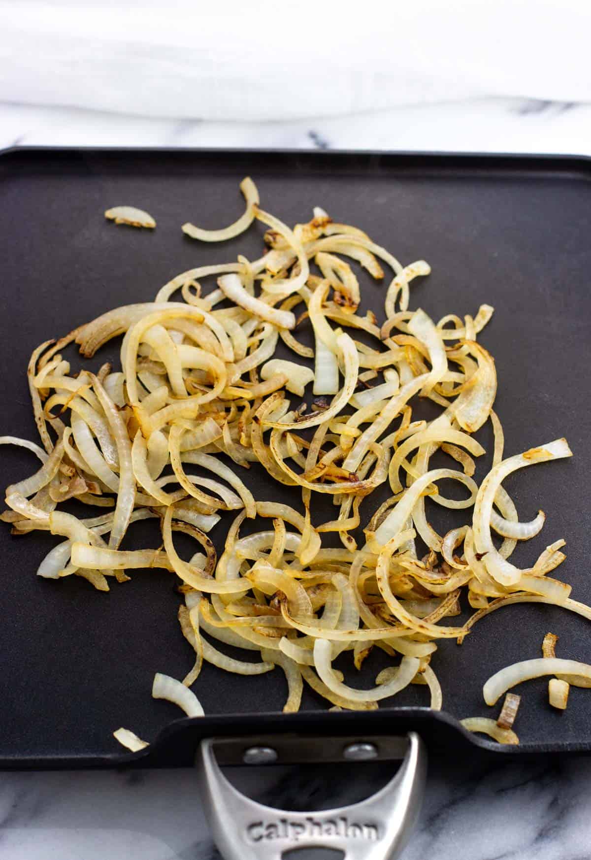 Sauted onions on a griddle pan.