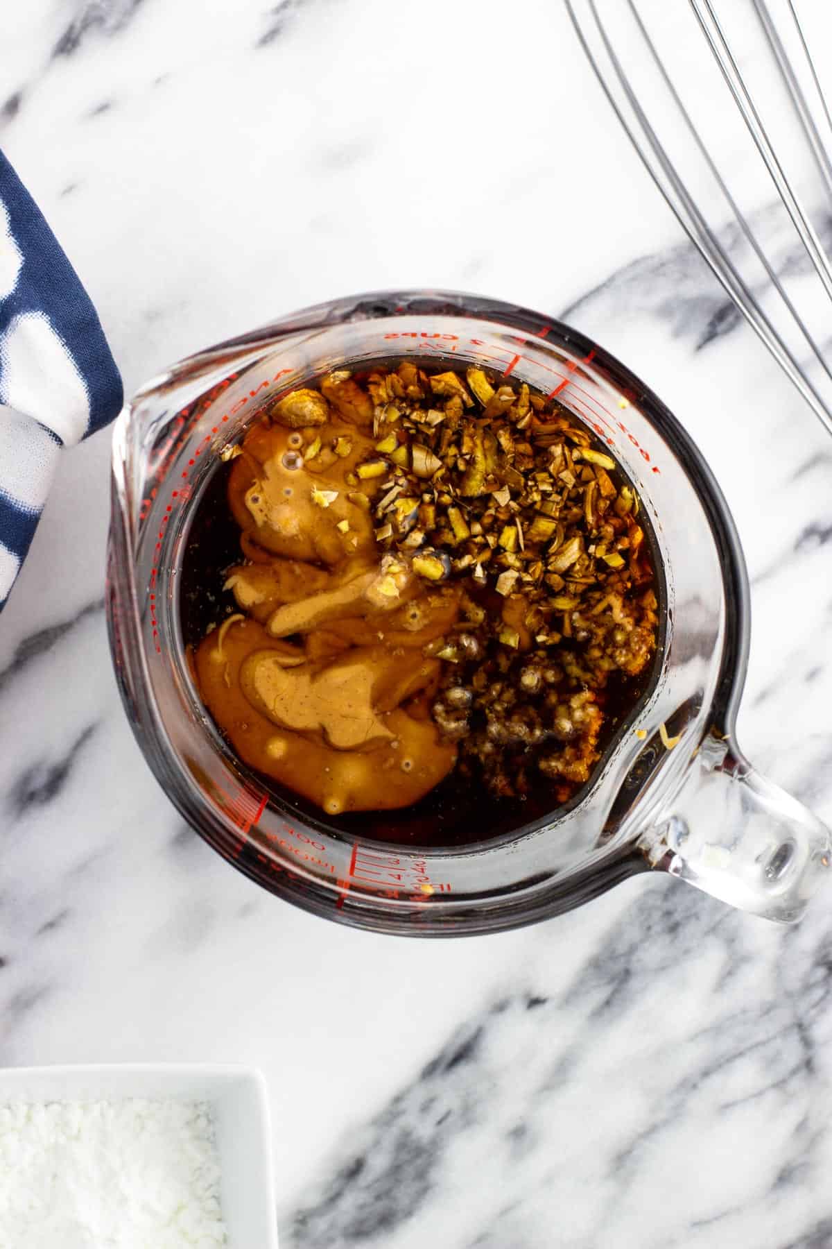 Stir fry sauce ingredients added to a measuring cup.