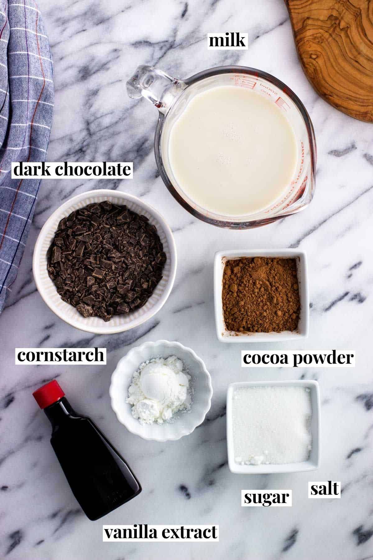 Italian hot chocolate ingredients labeled on a marble board.