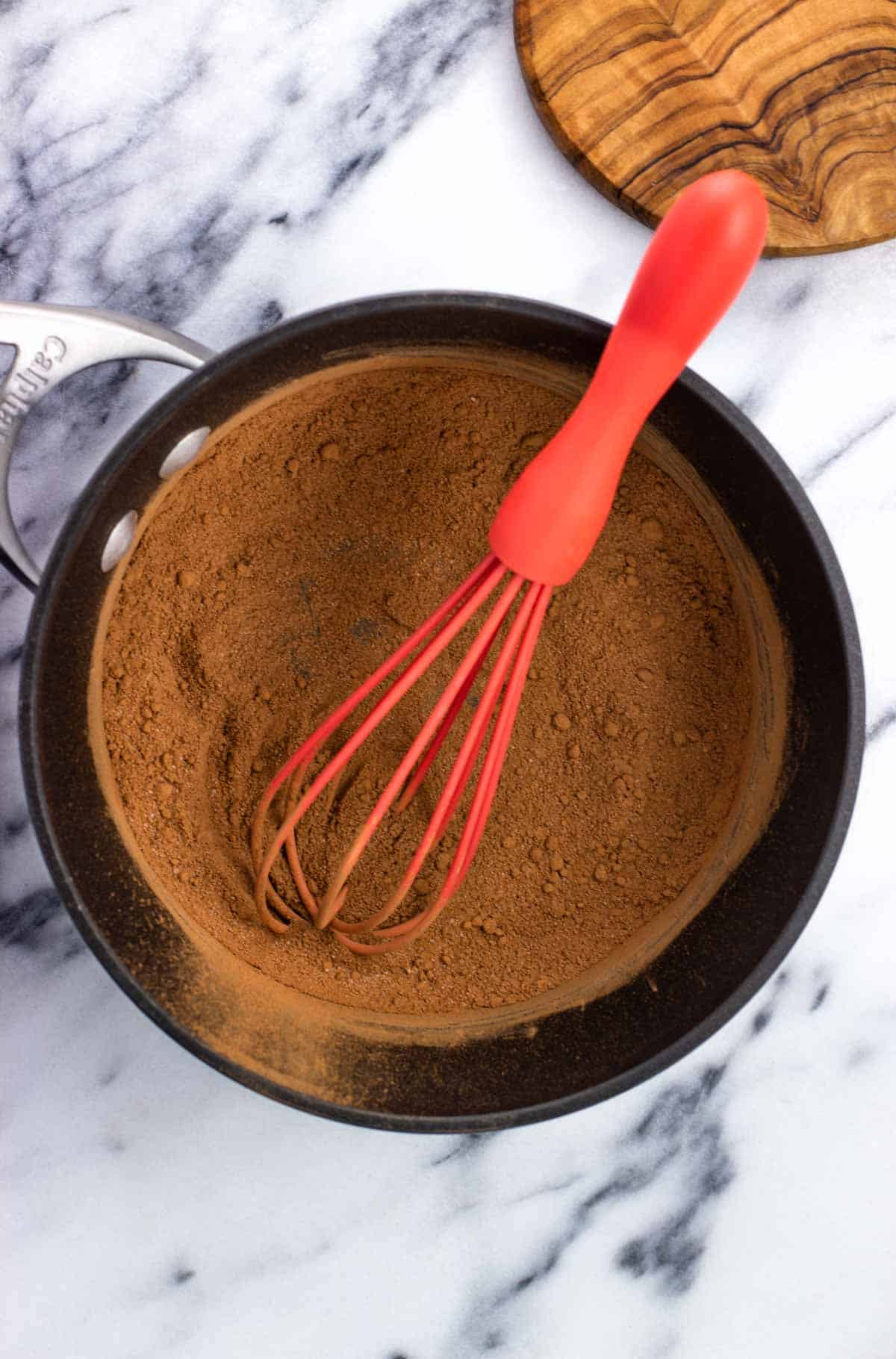 The dry ingredients combined in a small pan with a whisk.