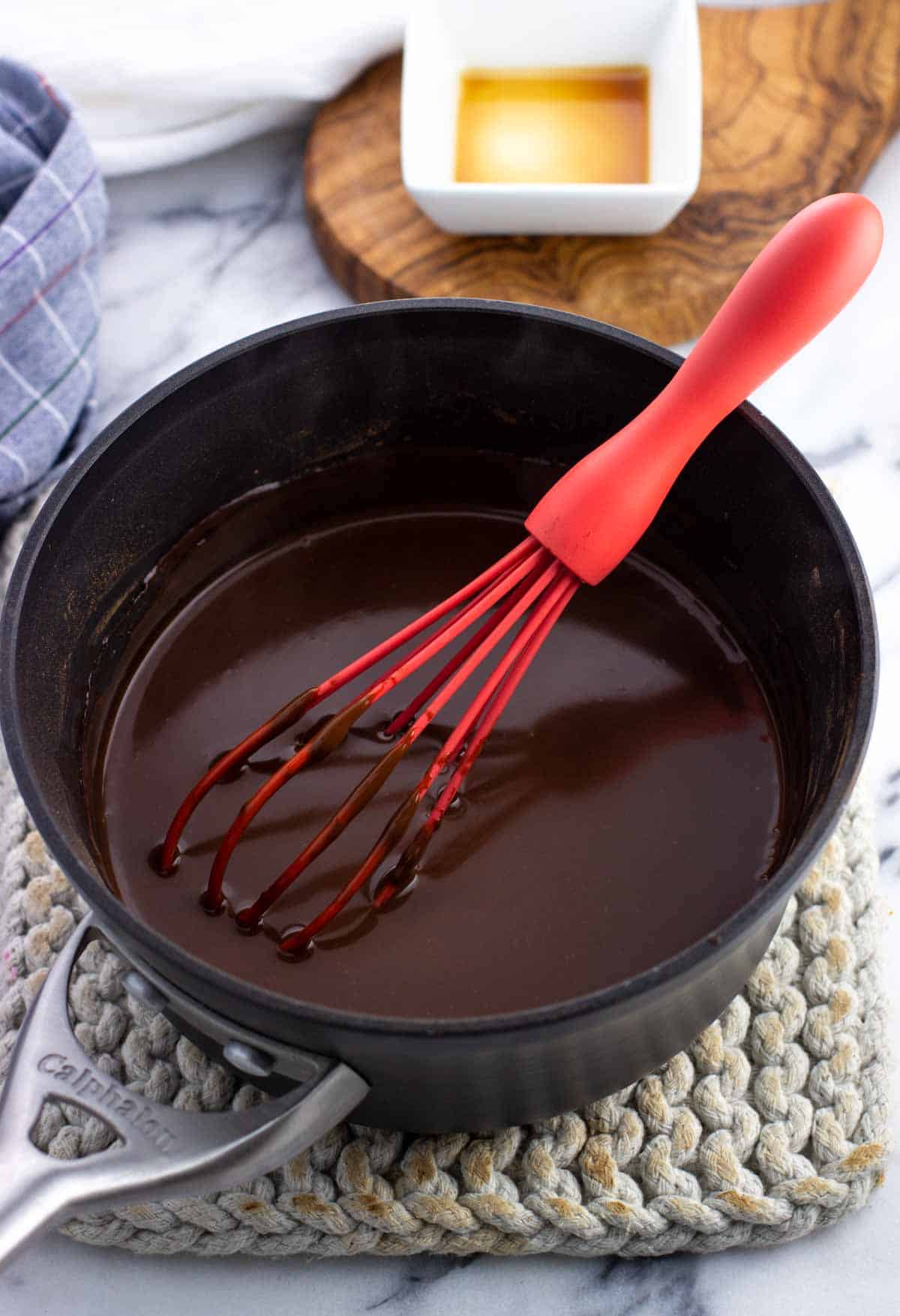 Thickened cioccolata calda in a pan with a whisk ready to serve.