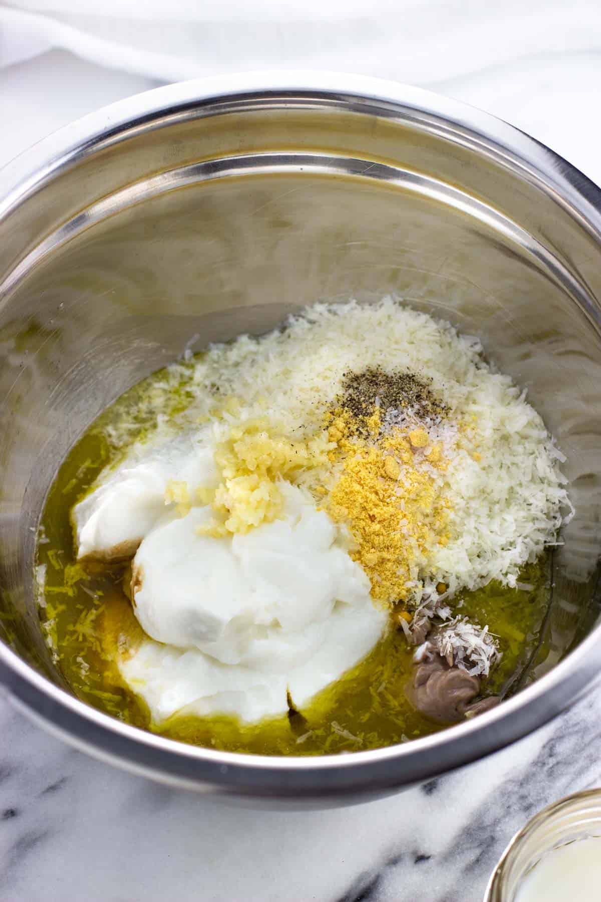 Dressing ingredients in a metal bowl.