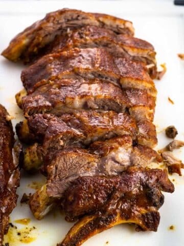 A half-rack of ribs sliced on a cutting board.