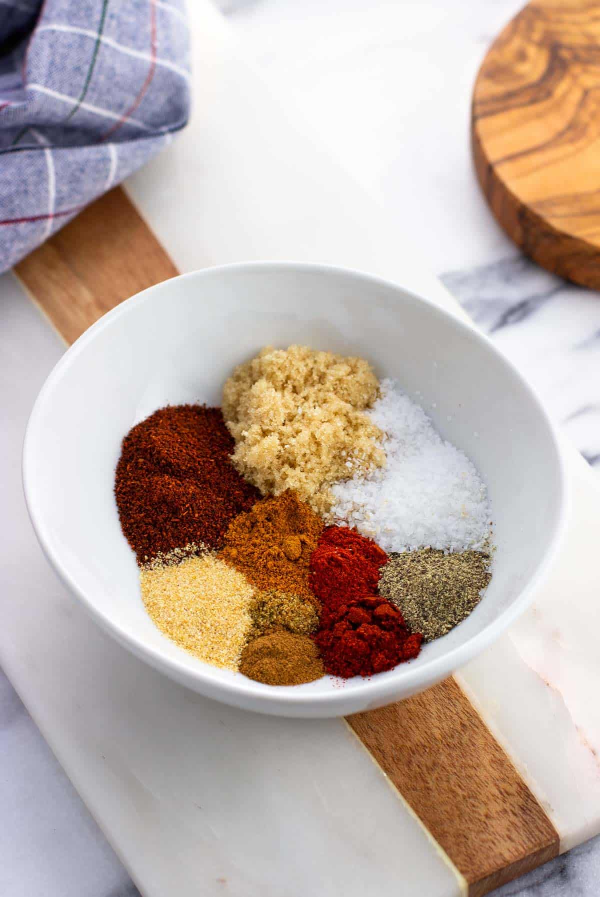 Spice rub ingredients separated in a bowl.