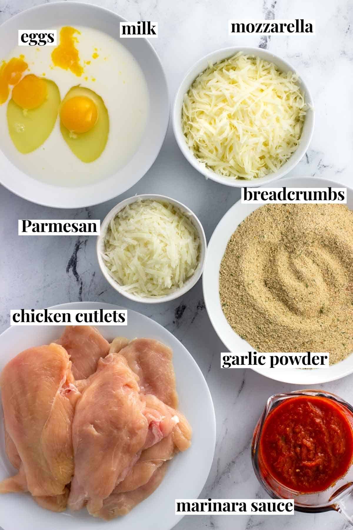 Labeled baked chicken parmesan ingredients in bowls.