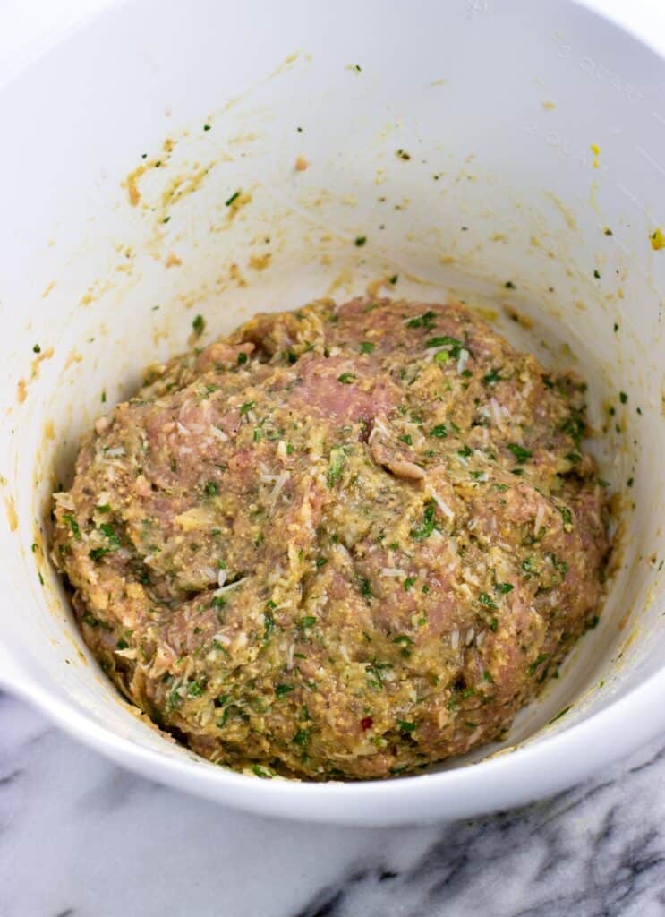 Thoroughly mixed together turkey meatball ingredients in a bowl.