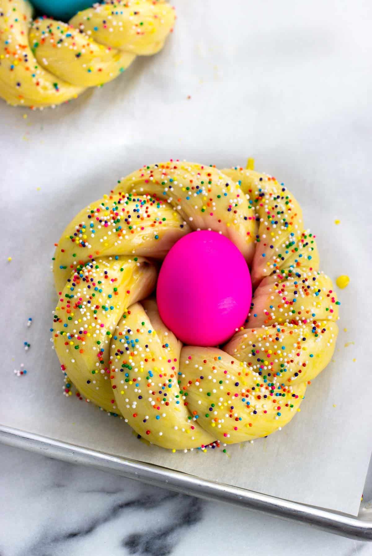 A ring of dough with a dyed Easter egg in the center.