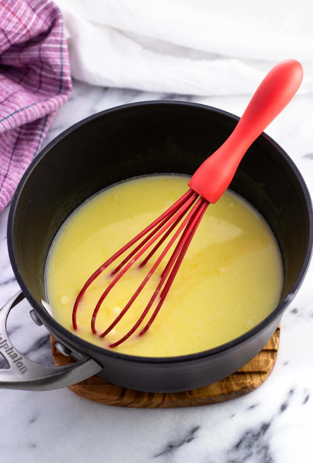 Melted butter and milk in a small saucepan with a whisk.