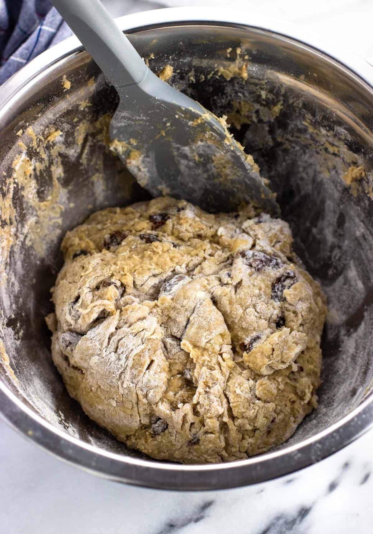 Maple Irish soda bread dough forming a shaggy ball in a mixing bowl.