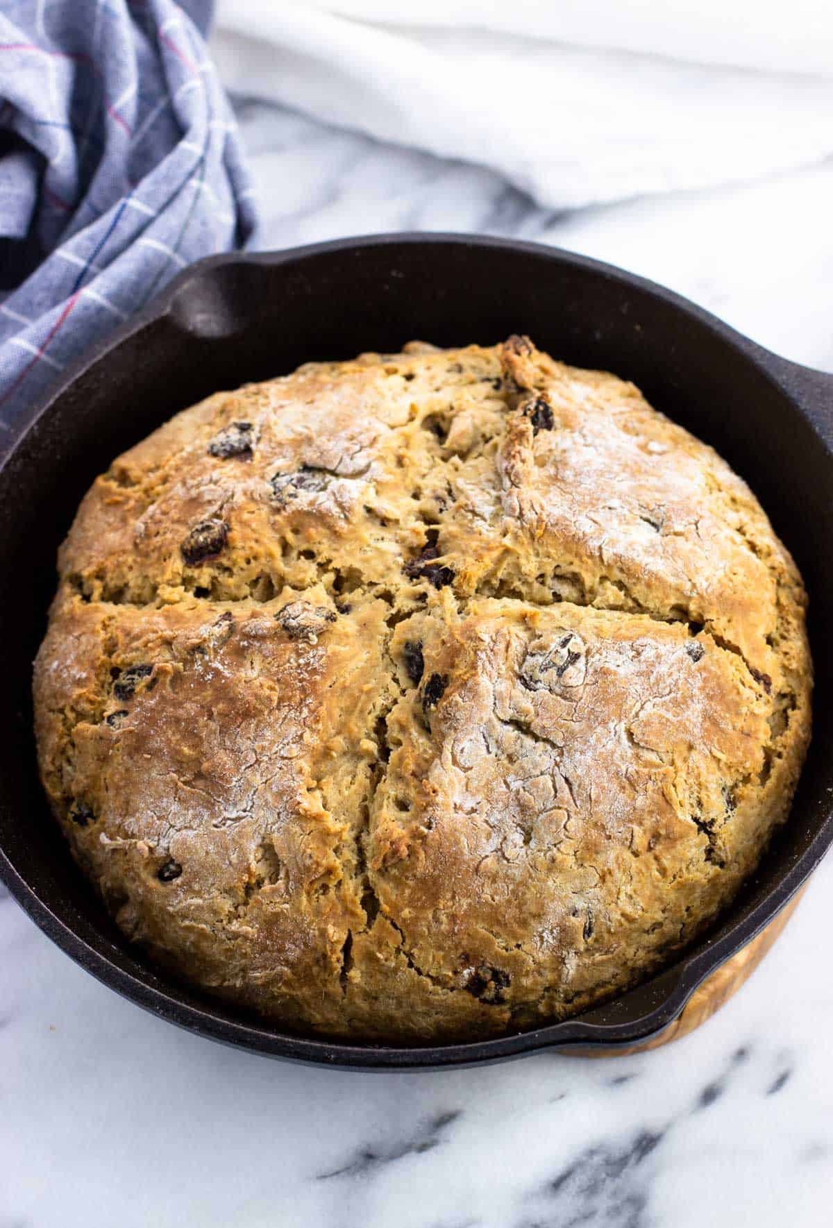 Baked maple Irish soda bread in a cast iron skillet.