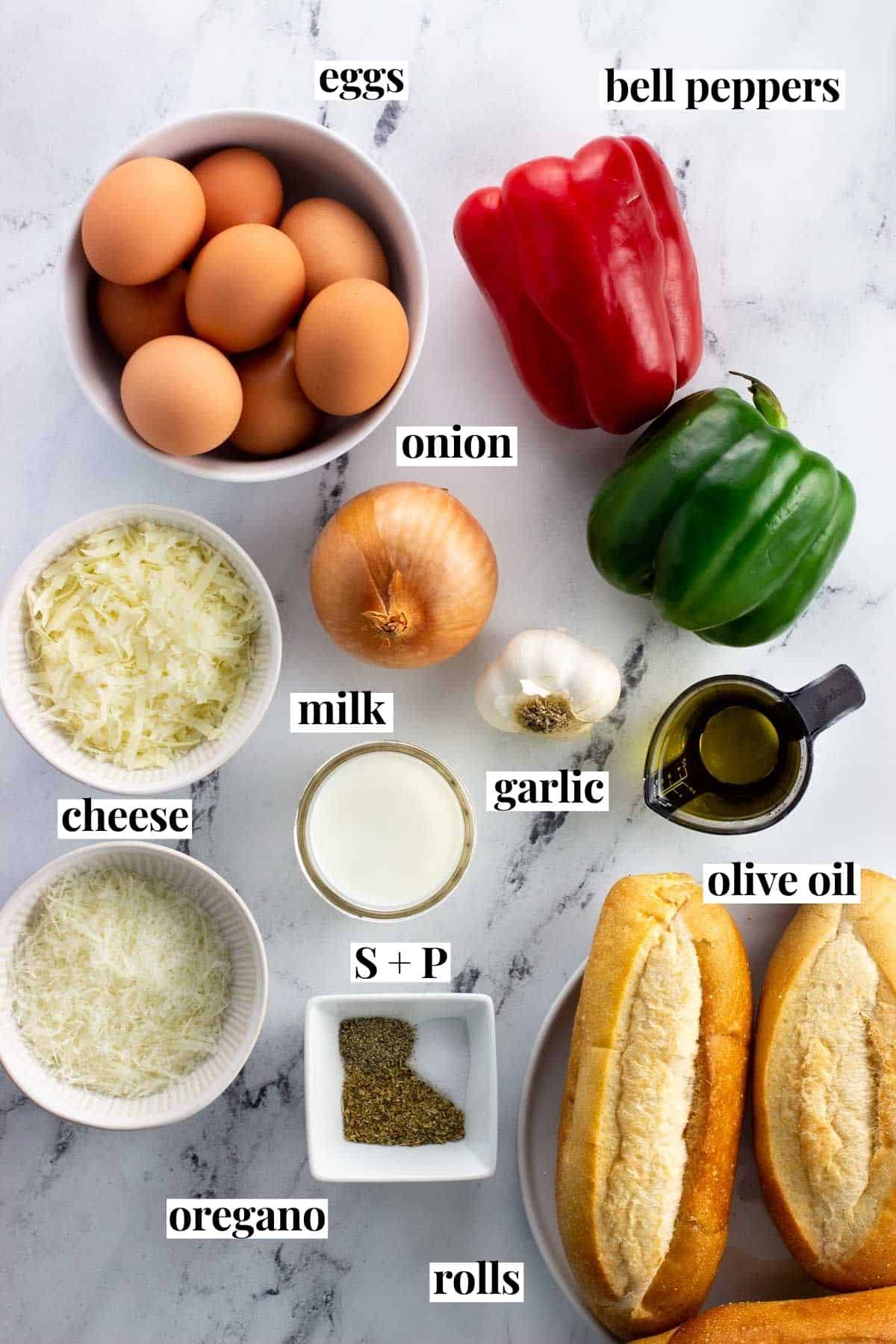 Labeled pepper and egg sandwich ingredients on a marble board.