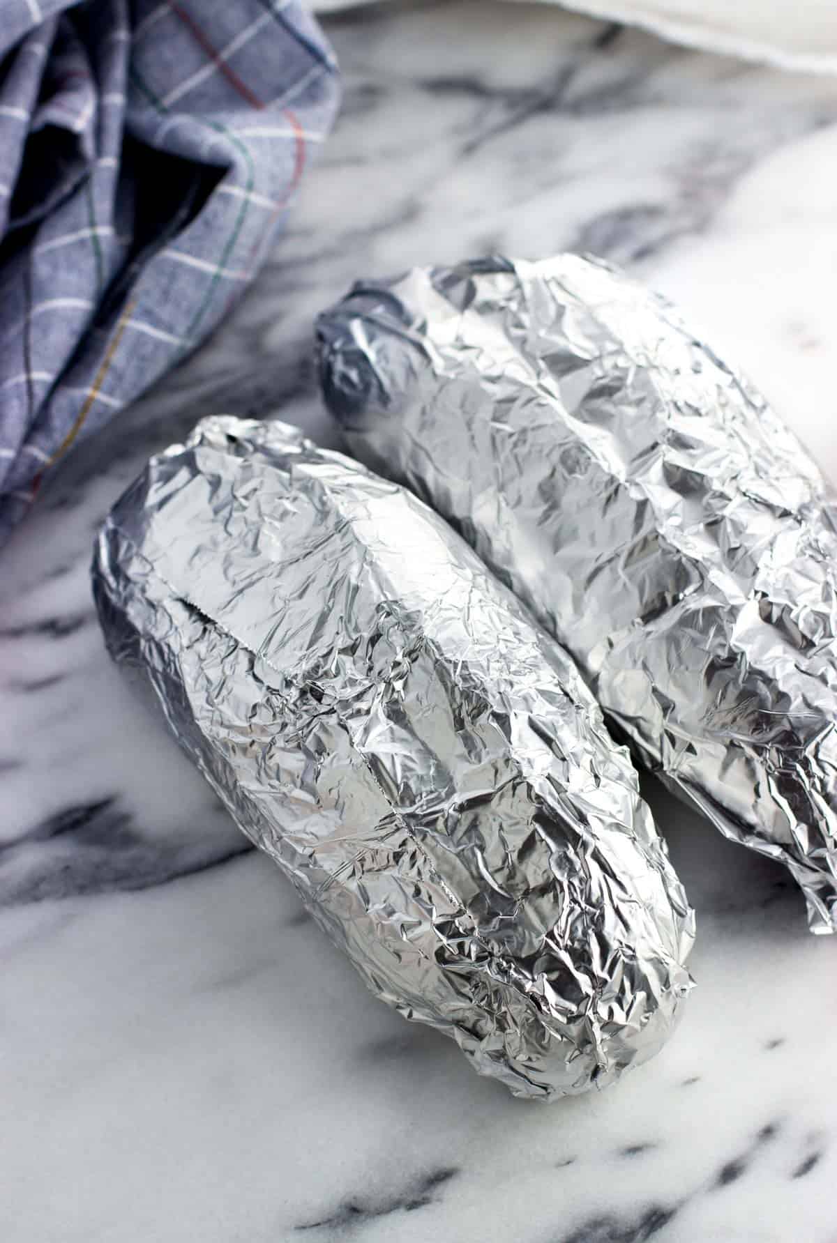 Two foil-wrapped rolls on a marble board.