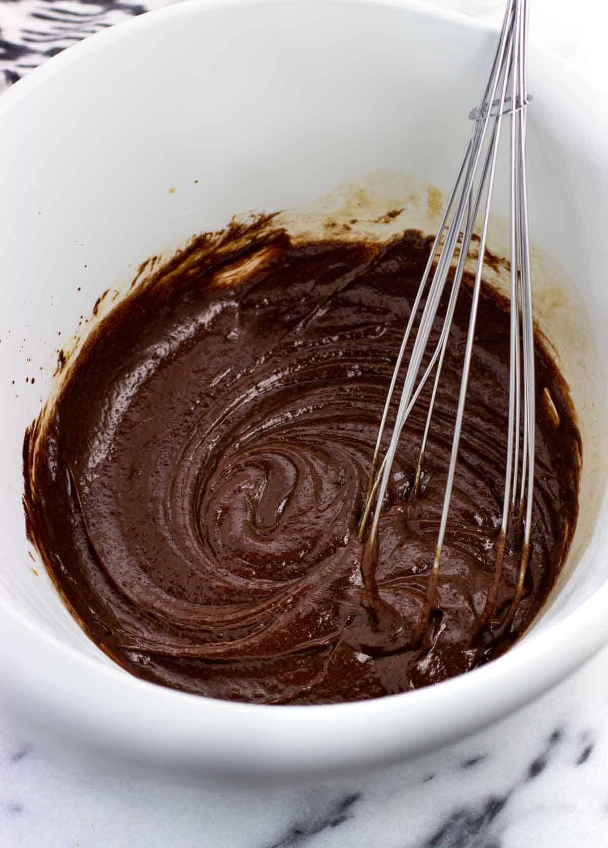 Melted butter, chocolate, and the wet ingredients whisked together in a bowl.