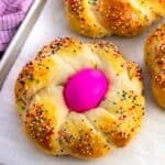 A baked Italian Easter bread loaf with an Easter egg in the middle.