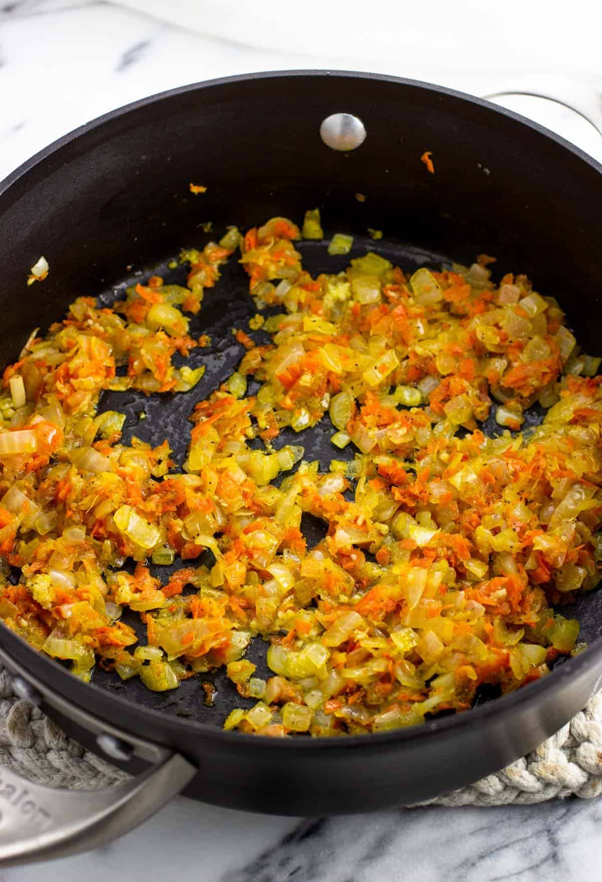 The sauteed vegetables in a pan.