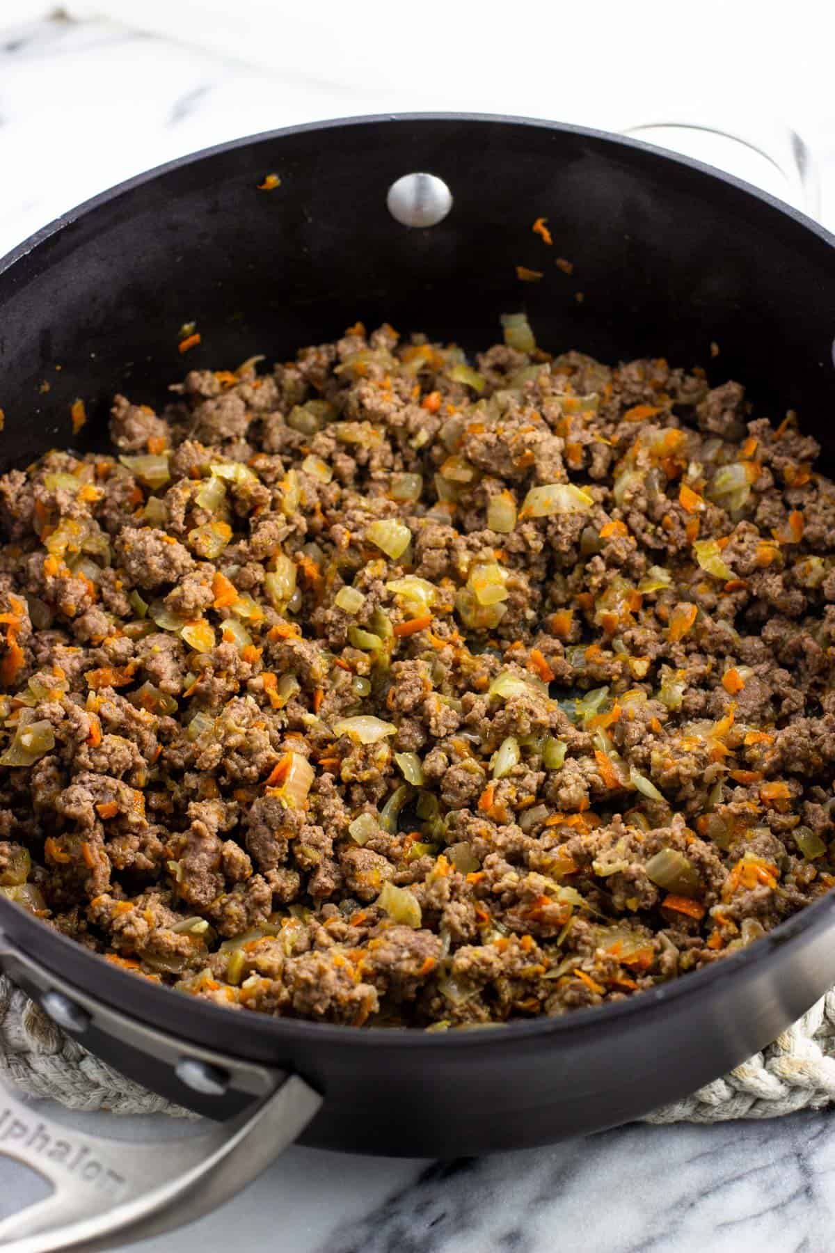 Beef cooked in the pan with the vegetables.