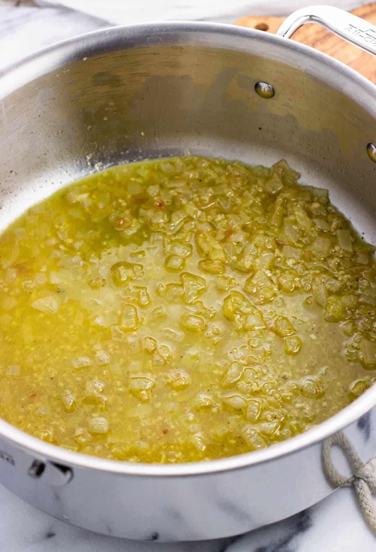 Wine and broth added to the pan with the onion.