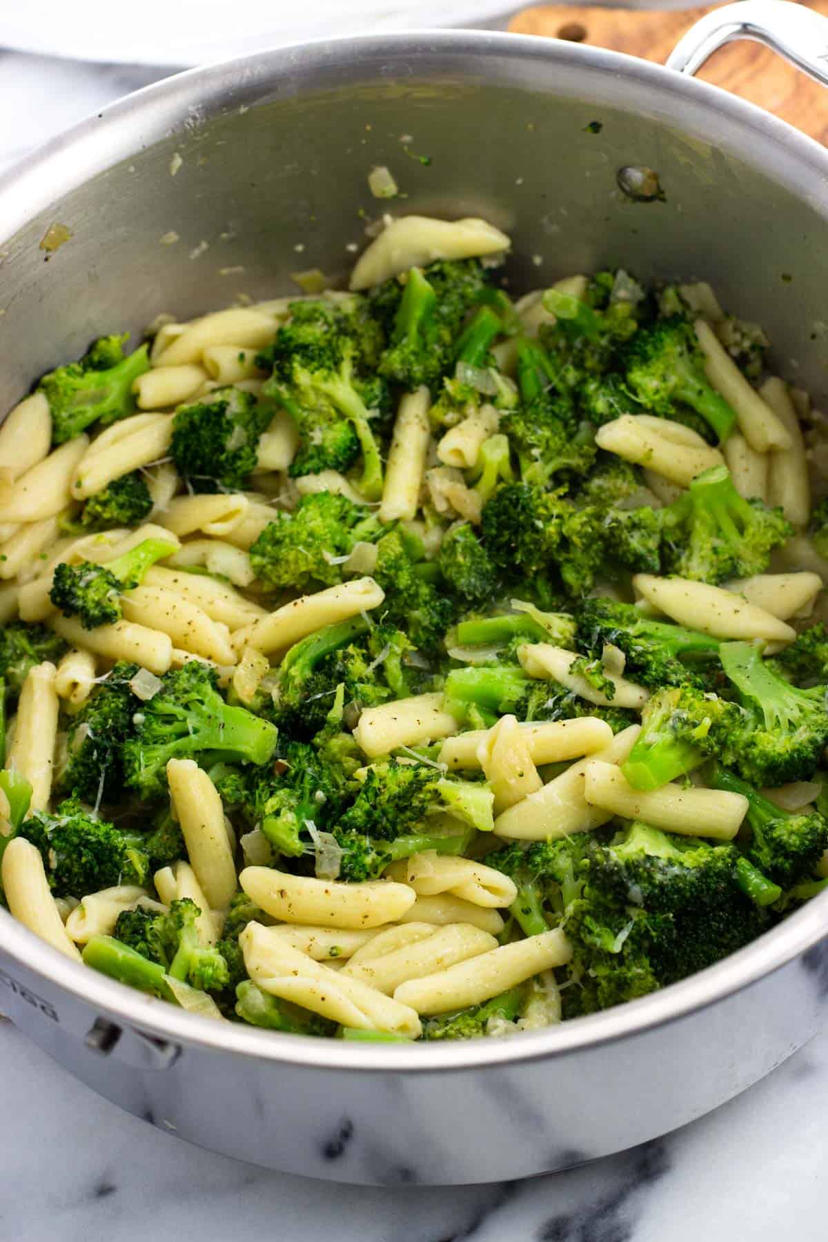 Cavatelli stirred into the broccoli and onion in the pan.