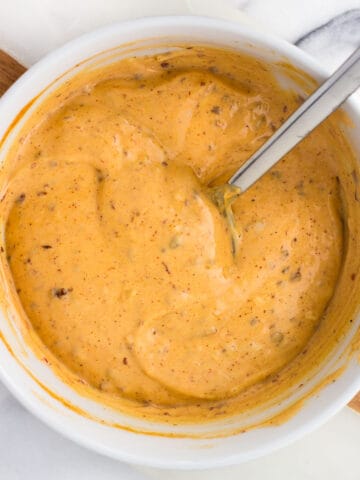 Chipotle aioli stirred together in a bowl.