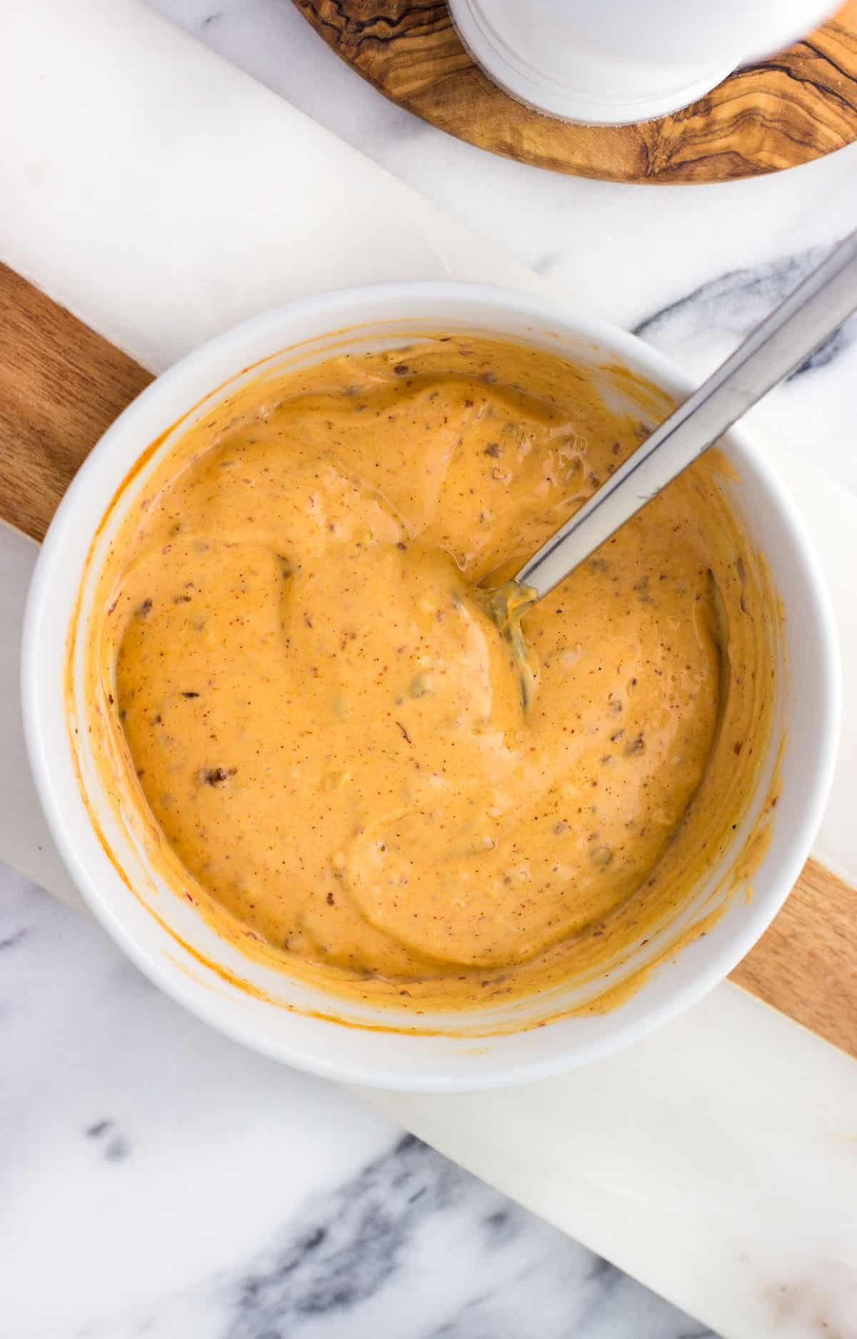 Chipotle aioli stirred together in a bowl.