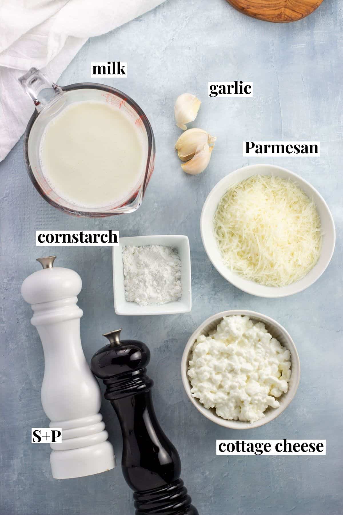 Labeled healthy alfredo sauce recipe ingredients in separate jars.