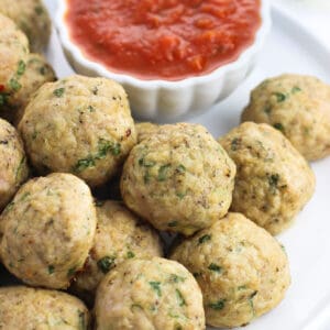 A plate of Italian turkey meatballs with marinara dipping sauce.