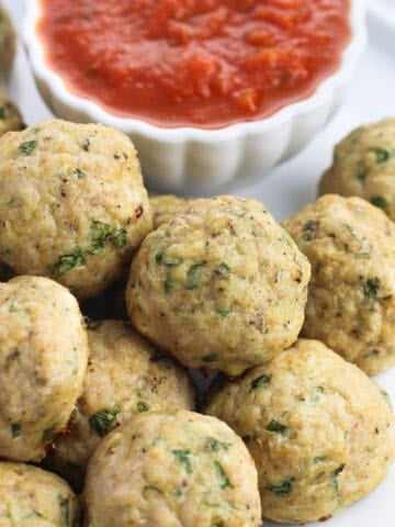 A plate of Italian turkey meatballs with marinara dipping sauce.