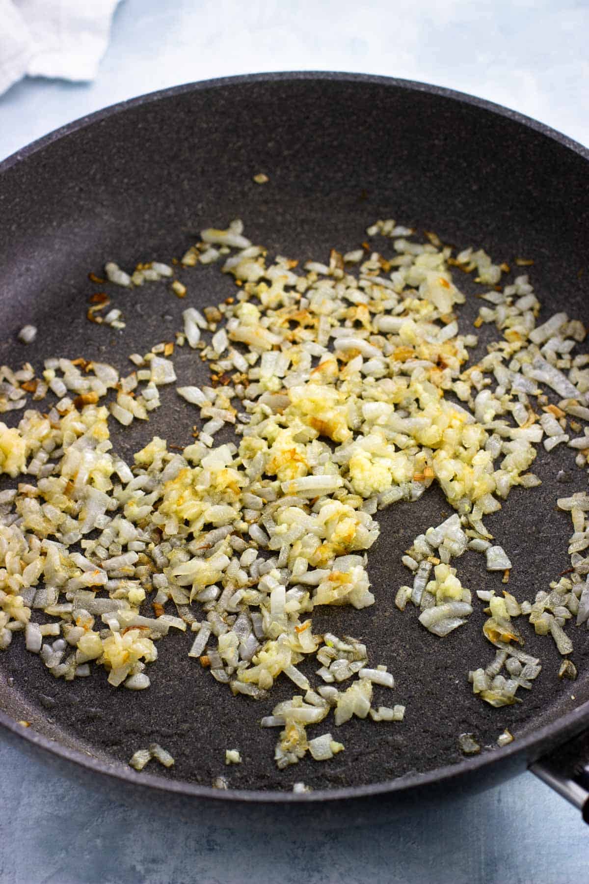 Sauteed onion and garlic in a pan.