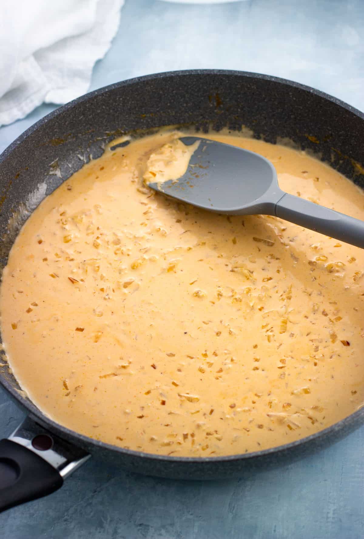 Cream poured into the pan to form the lobster ravioli sauce.
