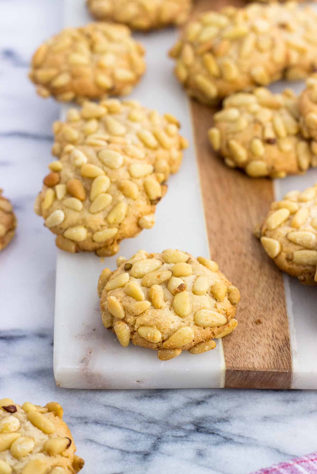 Pignoli cookies on a marble board.