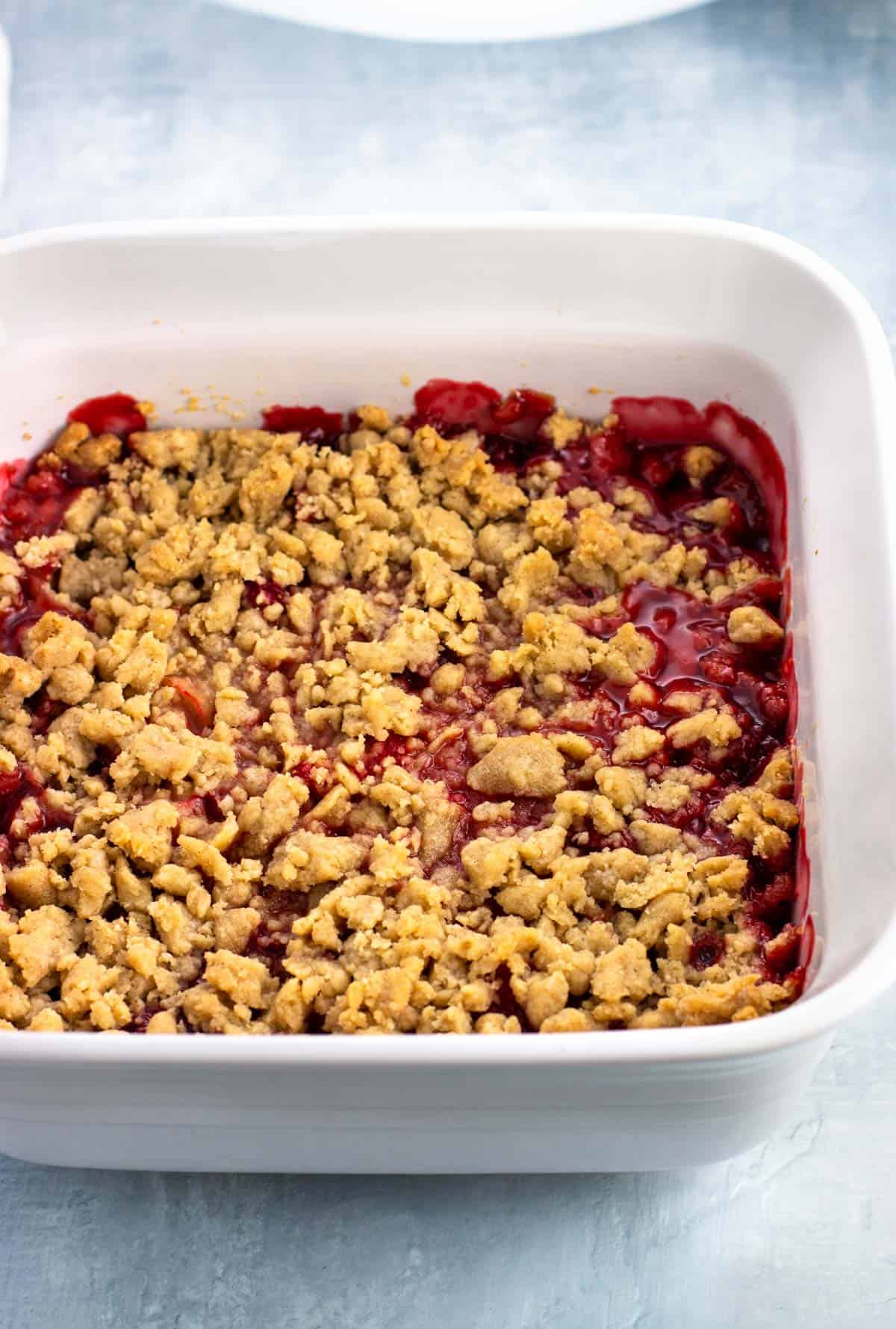 Baked strawberry rhubarb crumble in a baking dish.