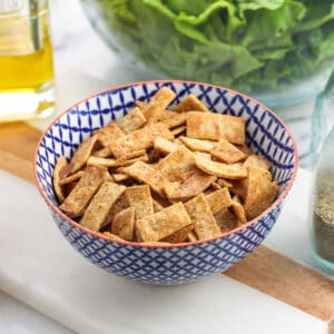 Baked tortilla strips in a small ceramic bowl.