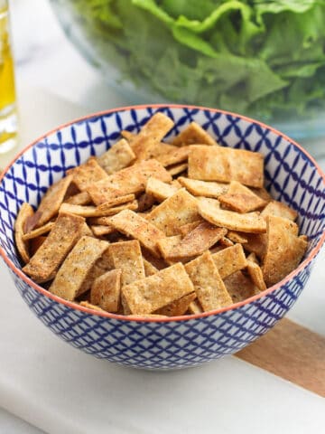 Baked tortilla strips in a small ceramic bowl.