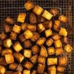 Air fryer croutons on a wire air fryer basket.