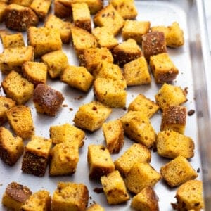 Baked croutons on a rimmed baking sheet.