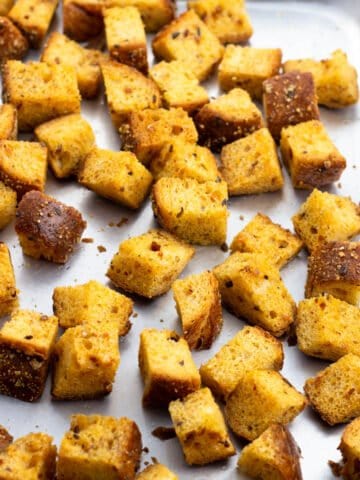Baked croutons on a rimmed baking sheet.
