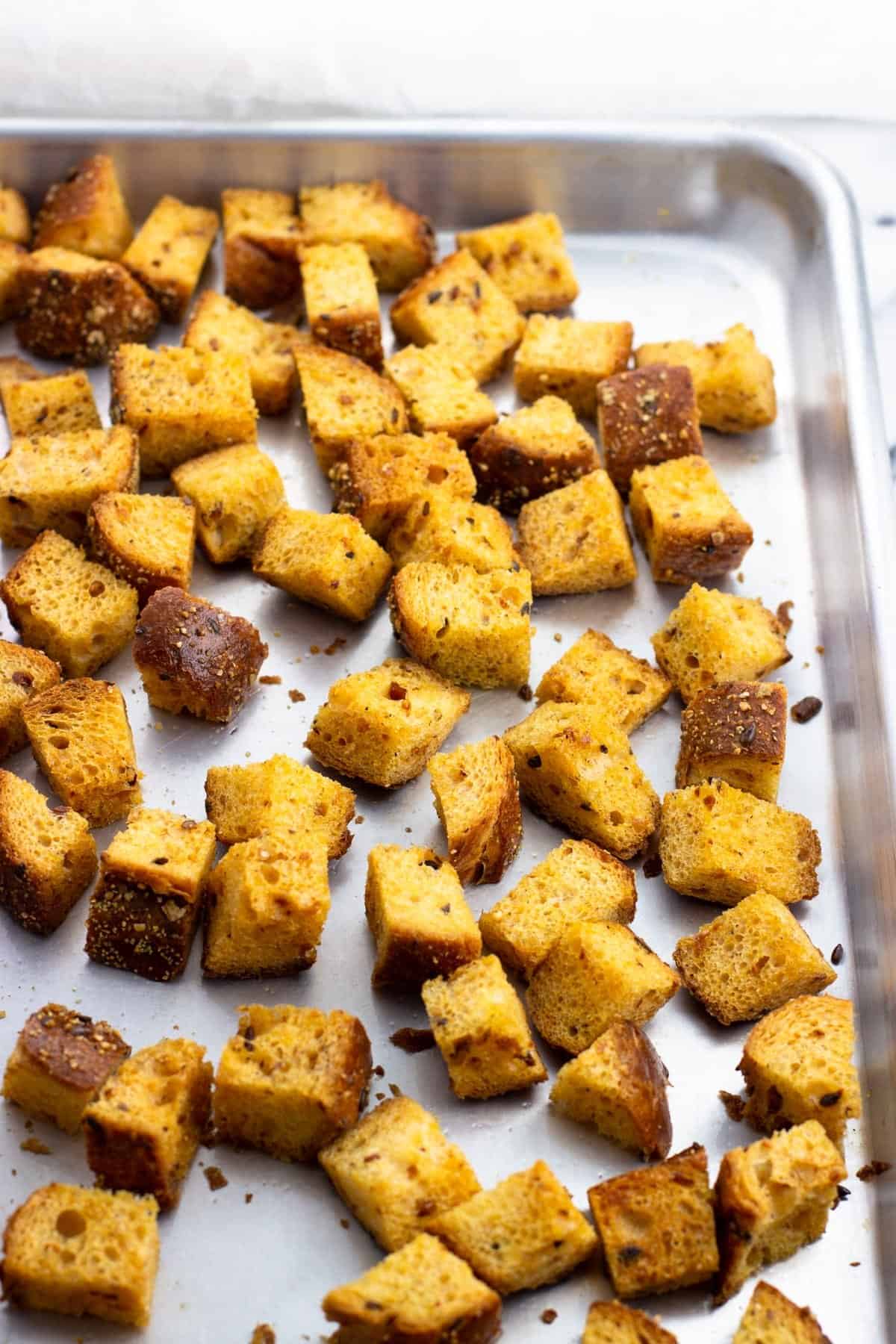 Baked croutons on a rimmed baking sheet.