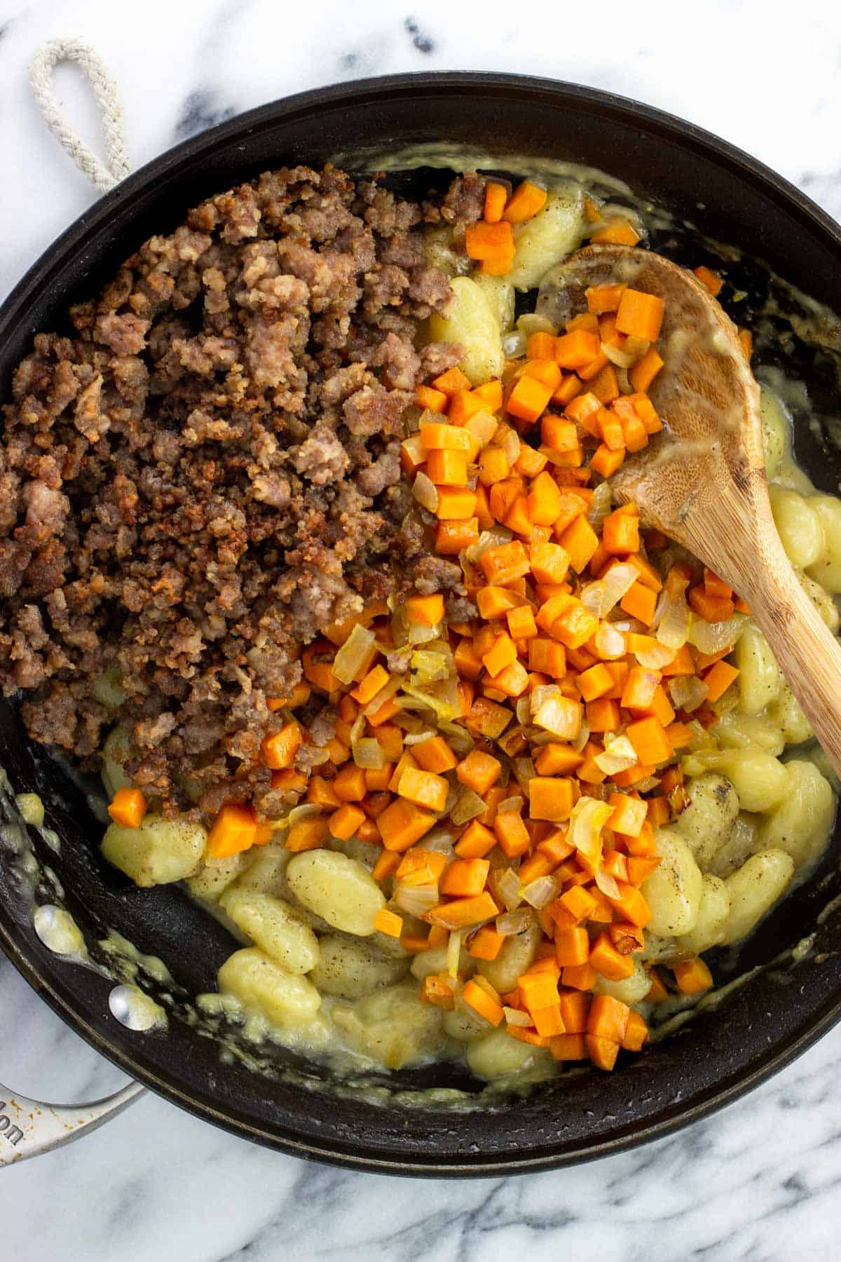 Cooked sausage and sweet potato added back to the gnocchi pan.