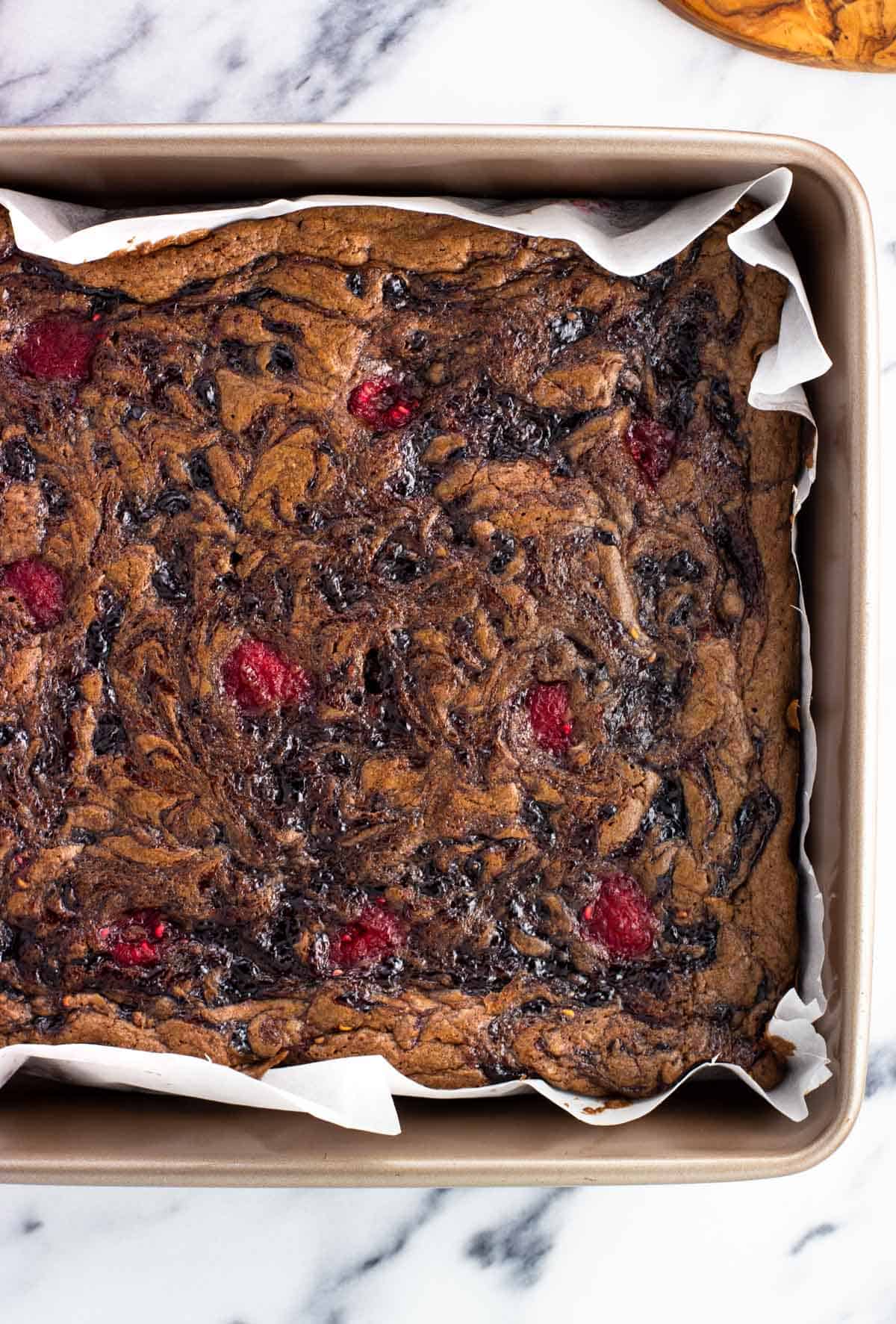 Baked raspberry brownies in a square pan.