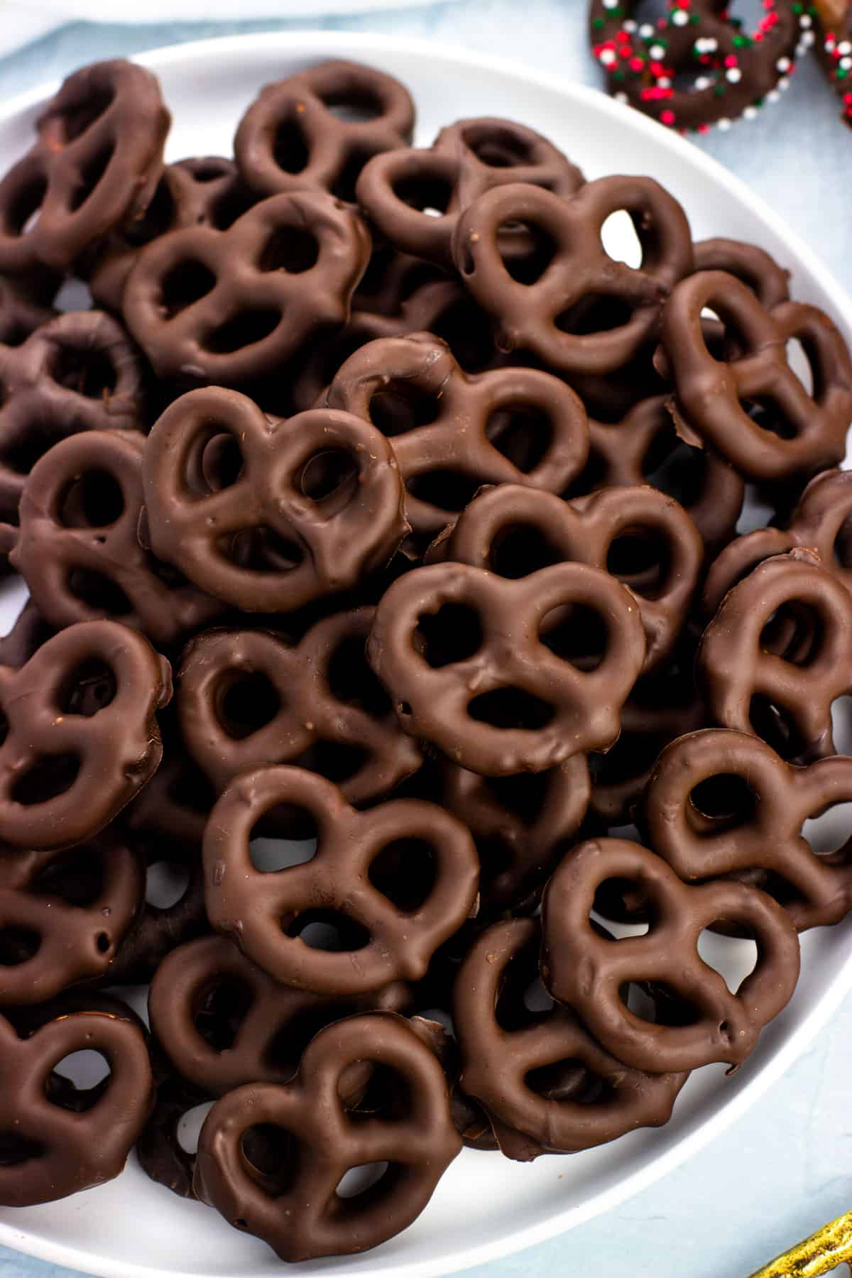 A plate filled with peppermint chocolate covered pretzels.