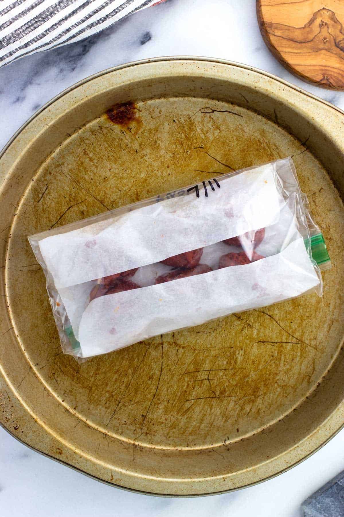 Frozen tomato paste blobs in a plastic bag.