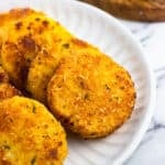 Pan-fried slices of polenta arranged on a serving plate.