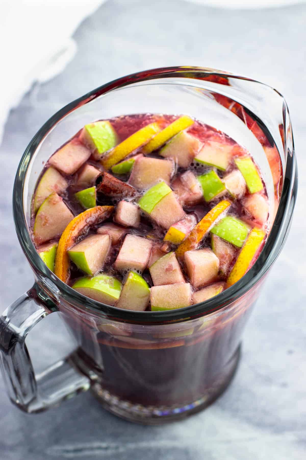 Finished mocktail sangria in a large glass pitcher ready to serve.