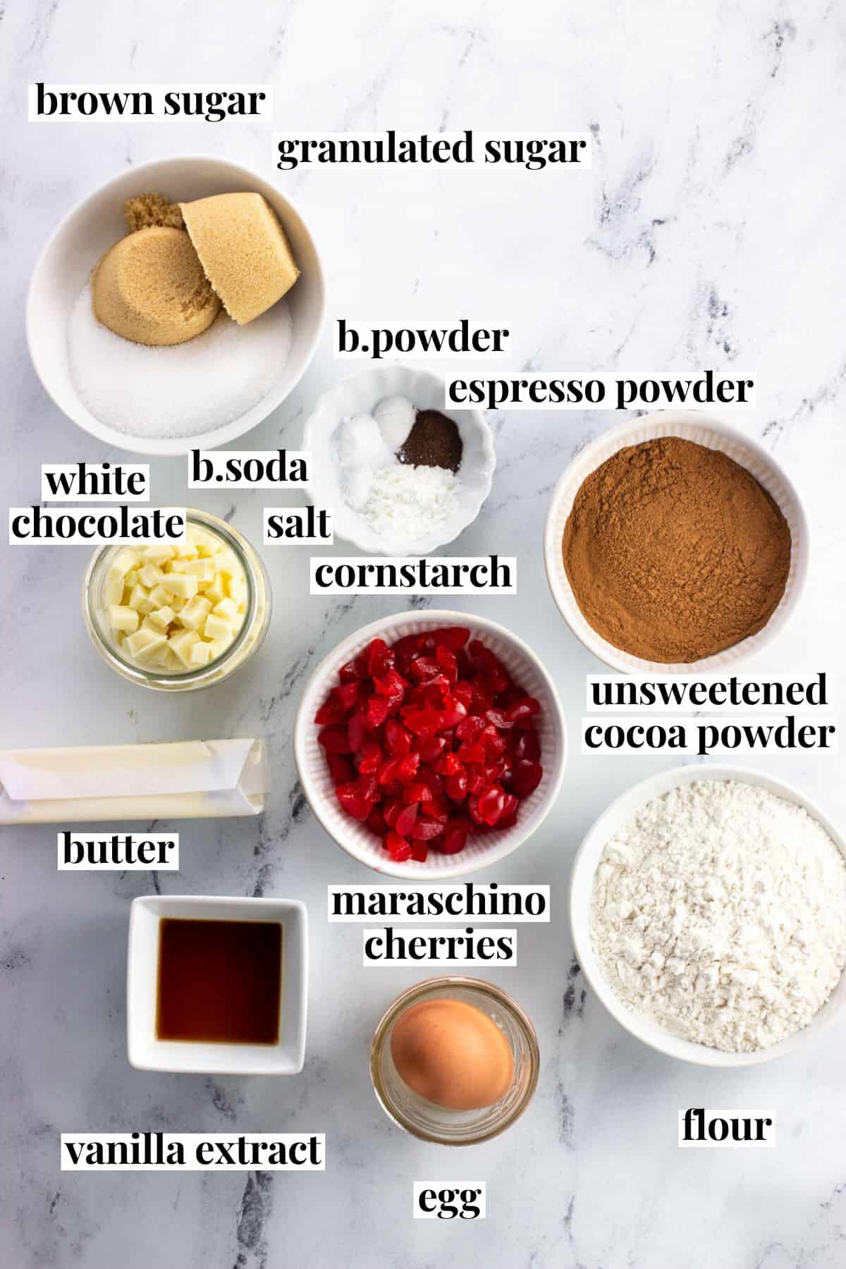 Labeled black forest cookie ingredients on a marble board.