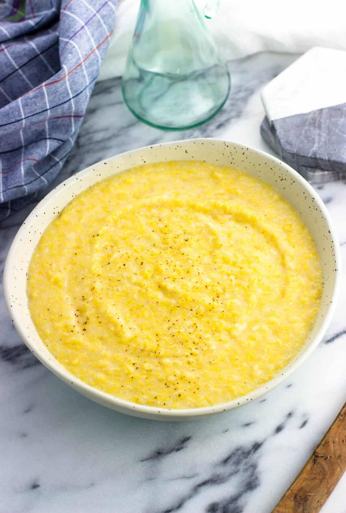 A serving bowl of easy creamy polenta made from a tube.