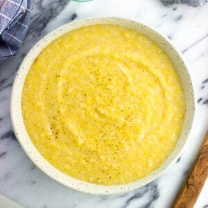 Creamy polenta made from a tube in a serving bowl.