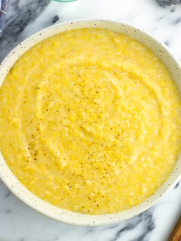 Creamy polenta made from a tube in a serving bowl.