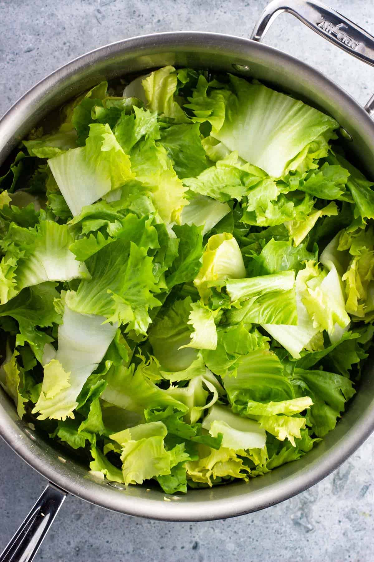 Chopped escarole added to the pot before wilting.