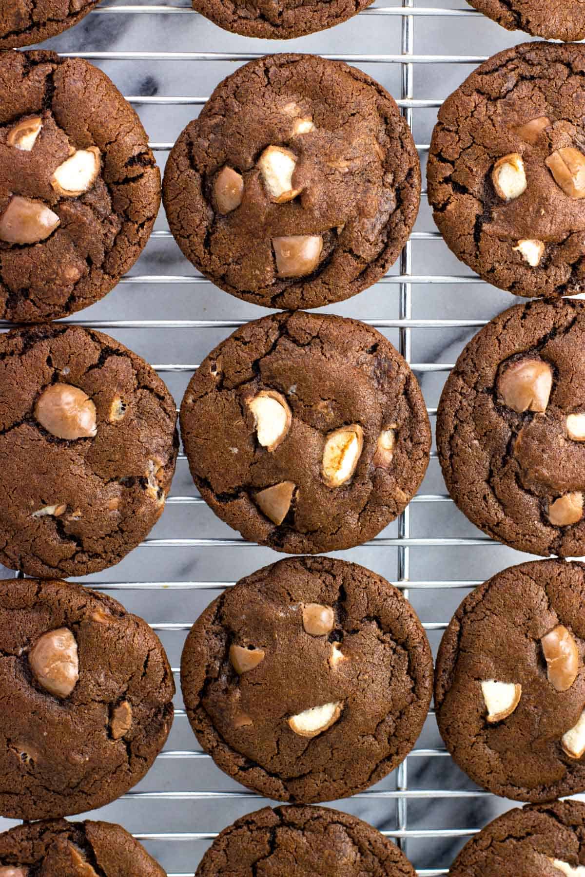 Whoppers cookies lined up on a cooling rack.